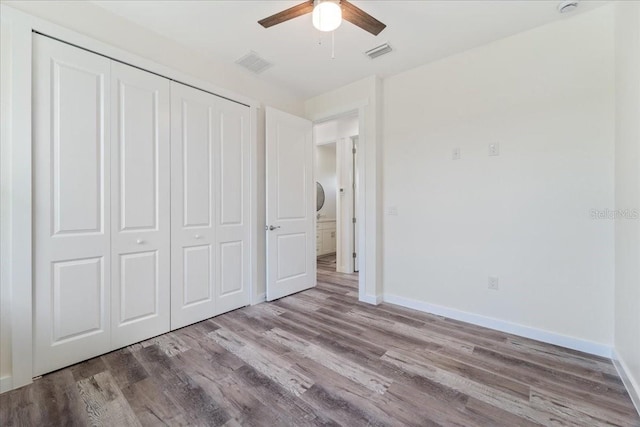 18290 Grace Ave, Port Charlotte, FL 33948 - unfurnished bedroom featuring wood finished floors, a closet, and a ceiling fan