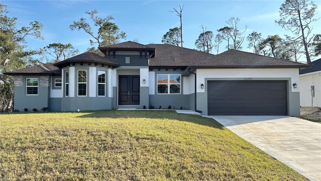 view of front facade with a garage and a front lawn