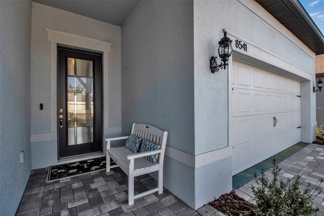 view of exterior entry with a garage