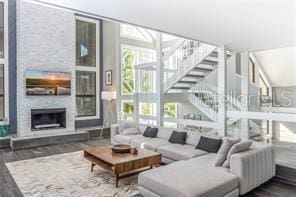 living room with dark hardwood / wood-style floors and a fireplace