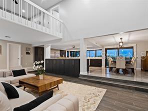 living room with a towering ceiling and hardwood / wood-style floors