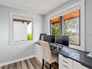 home office with hardwood / wood-style flooring