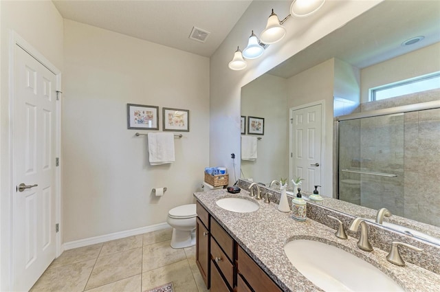 bathroom featuring vanity, tile patterned flooring, a shower with shower door, and toilet