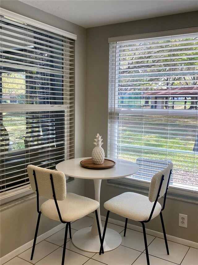 dining space with a healthy amount of sunlight and light tile patterned floors