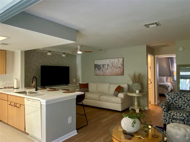 living room with sink, ceiling fan, and light hardwood / wood-style floors