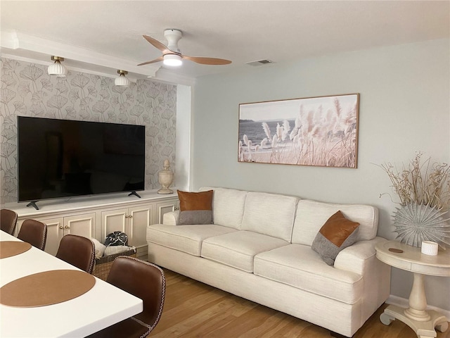 living room with hardwood / wood-style floors and ceiling fan