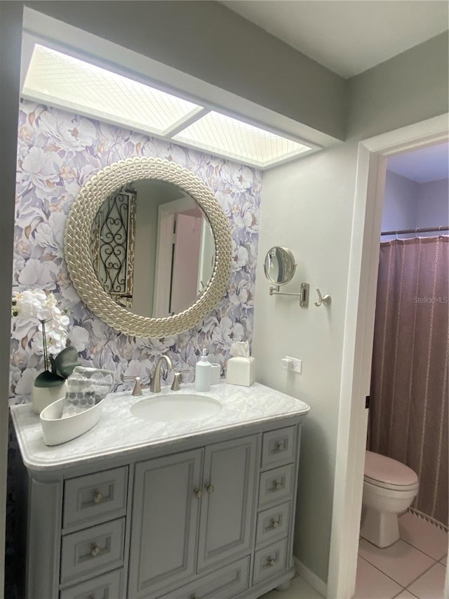 bathroom featuring vanity, toilet, and tile patterned floors
