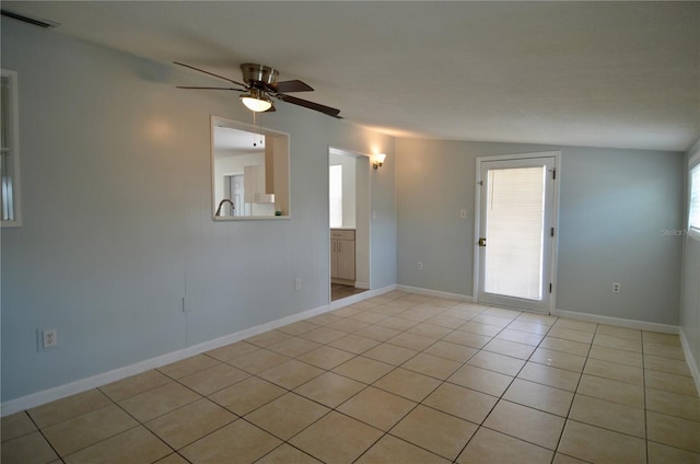 spare room with light tile patterned flooring and ceiling fan