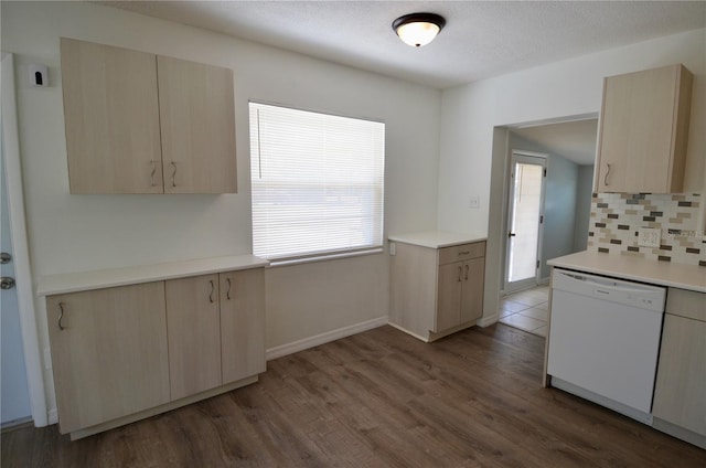 kitchen with hardwood / wood-style flooring, backsplash, white dishwasher, a textured ceiling, and light brown cabinets