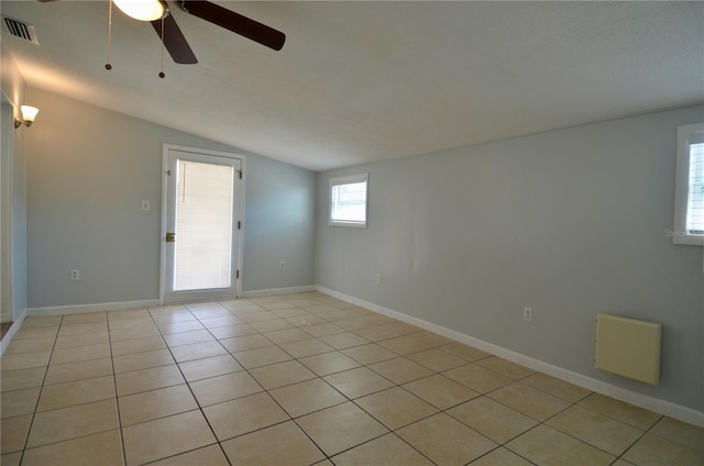 unfurnished room with light tile patterned flooring, ceiling fan, and lofted ceiling