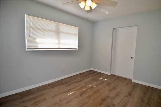 spare room featuring ceiling fan and dark hardwood / wood-style flooring