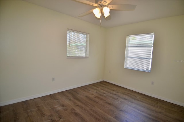 unfurnished room featuring dark wood-type flooring, plenty of natural light, and ceiling fan