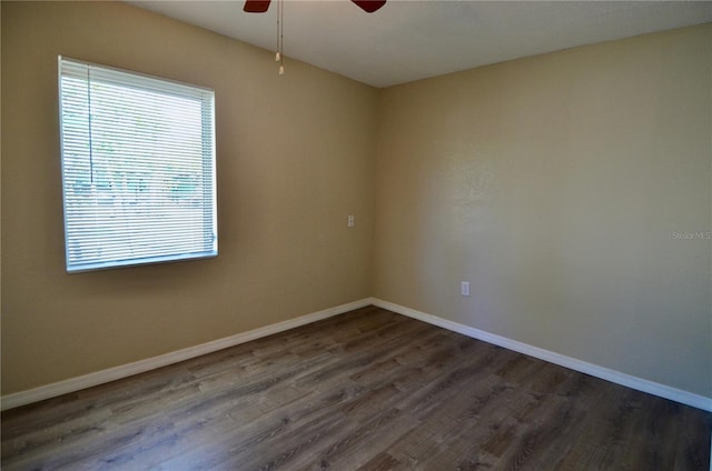 empty room featuring ceiling fan and dark hardwood / wood-style flooring