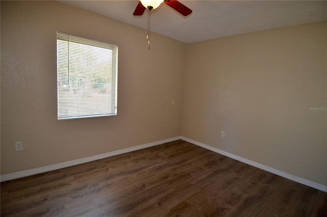 empty room featuring dark hardwood / wood-style floors and ceiling fan