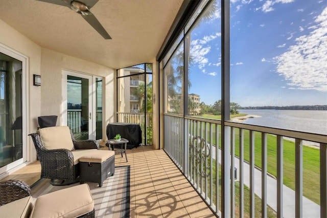 sunroom / solarium featuring a water view