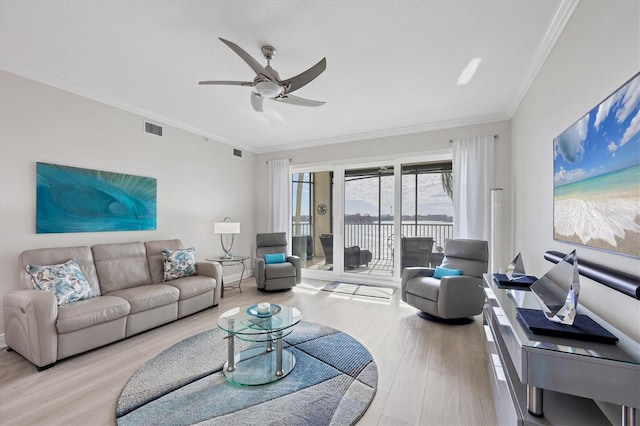 living room with light hardwood / wood-style flooring, ceiling fan, and ornamental molding