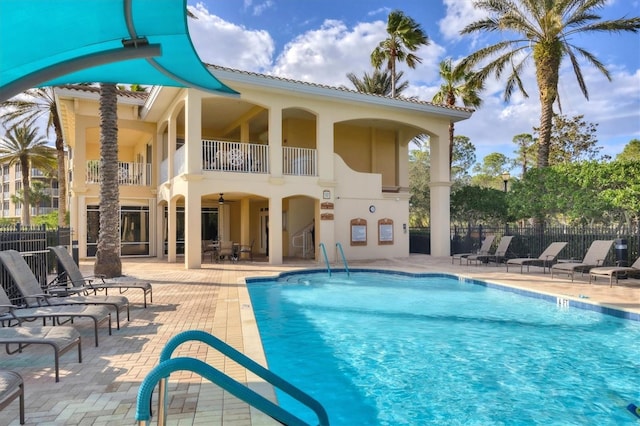 view of swimming pool featuring a patio and ceiling fan