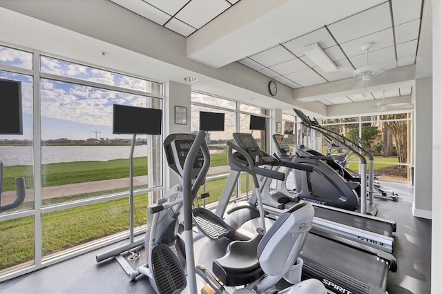 workout area featuring a healthy amount of sunlight and a paneled ceiling