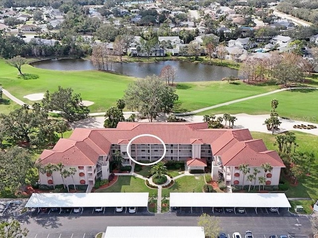 bird's eye view with a water view and view of golf course