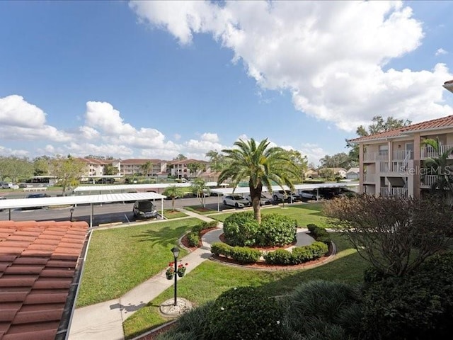 surrounding community featuring a residential view and a lawn