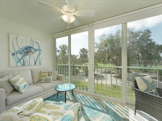 sunroom featuring a ceiling fan