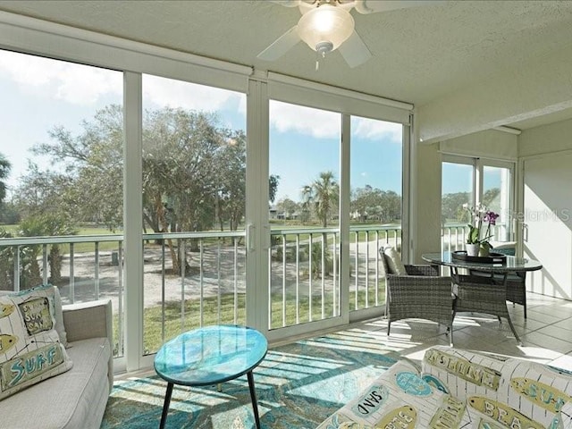 sunroom / solarium with a ceiling fan