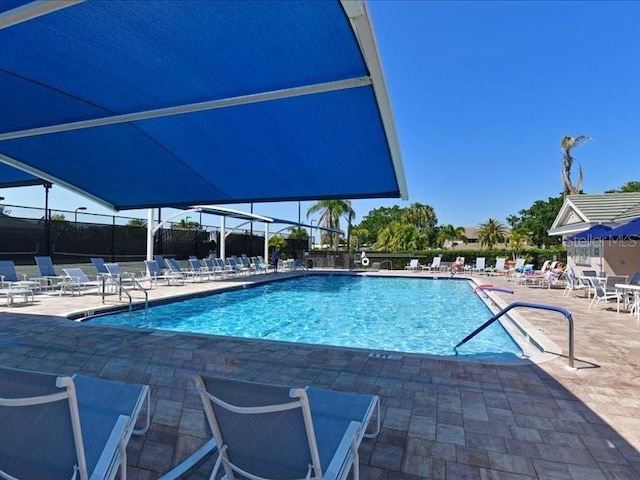 community pool featuring a patio area and fence