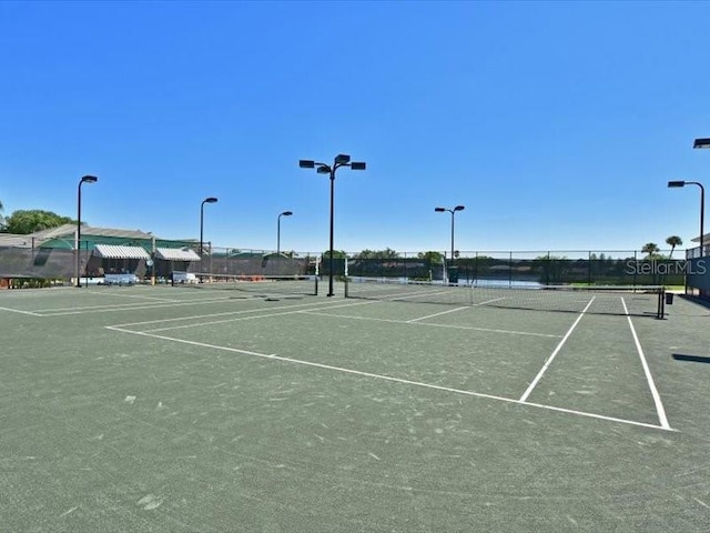 view of tennis court with fence