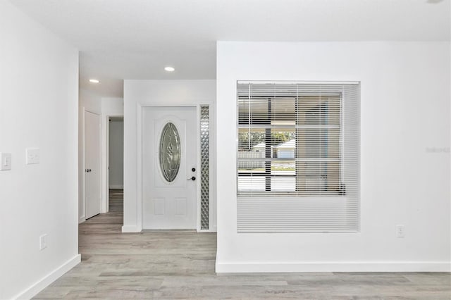 foyer with recessed lighting, wood finished floors, and baseboards