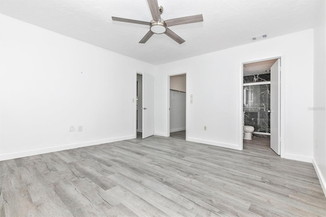 unfurnished bedroom with light wood-style flooring, baseboards, and visible vents