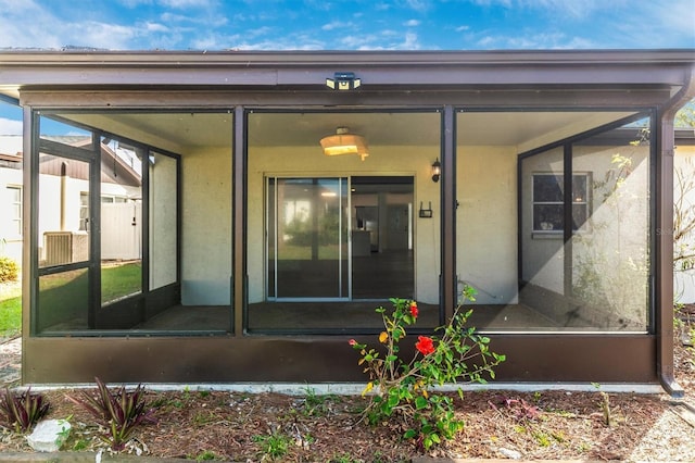 property entrance with stucco siding