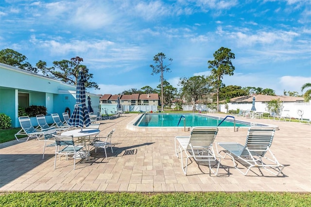 pool featuring a patio and fence