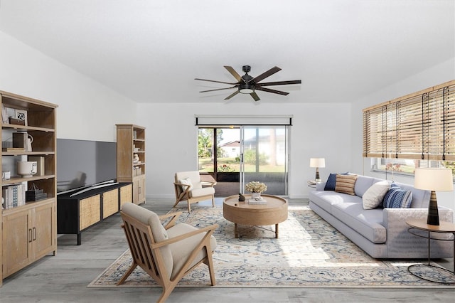 living room featuring light wood finished floors and ceiling fan