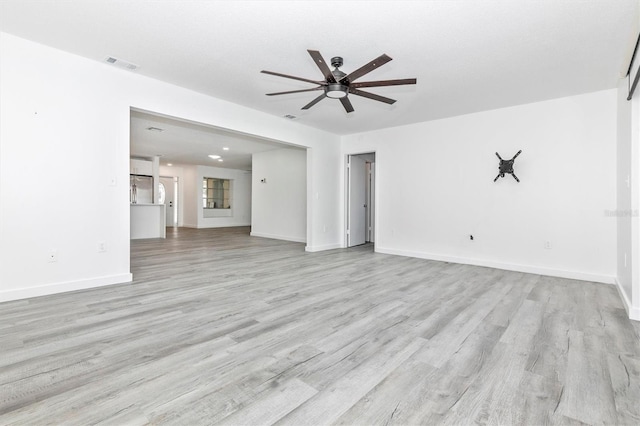 unfurnished living room featuring ceiling fan, baseboards, visible vents, and light wood-type flooring