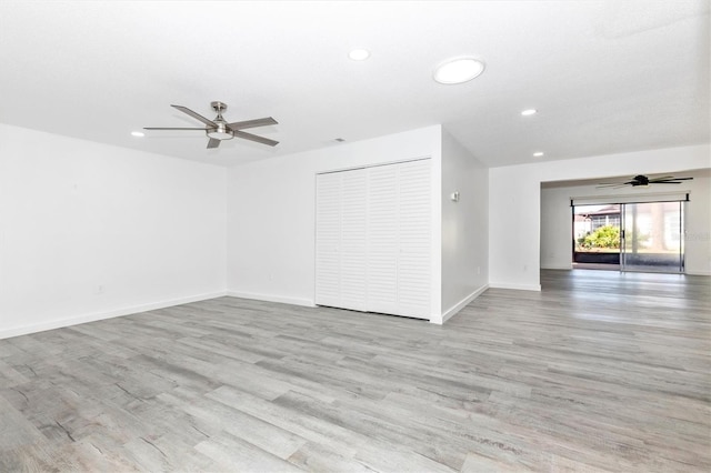 spare room featuring recessed lighting, baseboards, light wood-style floors, and ceiling fan