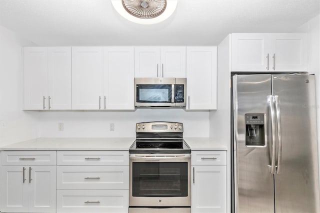 kitchen with white cabinetry, light countertops, and appliances with stainless steel finishes