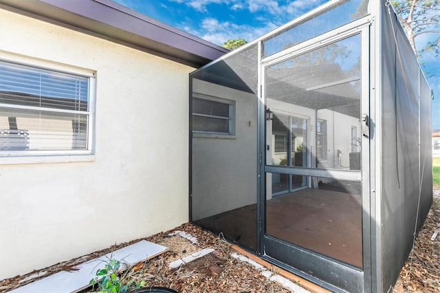 entrance to property with stucco siding