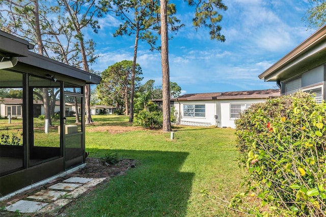 view of yard featuring a sunroom