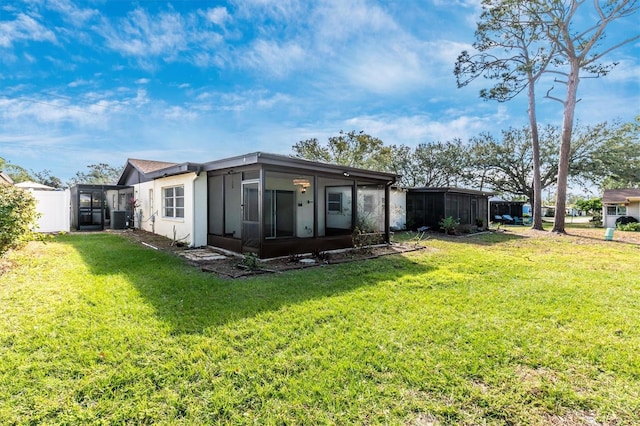 rear view of property with a lawn, cooling unit, fence, and a sunroom