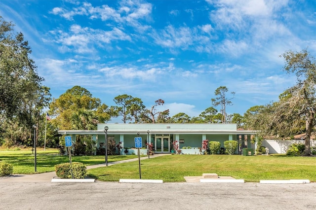 ranch-style house featuring french doors and a front lawn