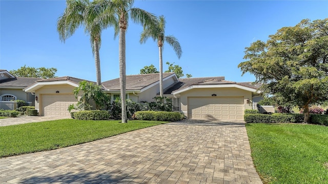 4060 Penshurst Park, Sarasota, FL 34235 - view of front of property with stucco siding, decorative driveway, and a garage