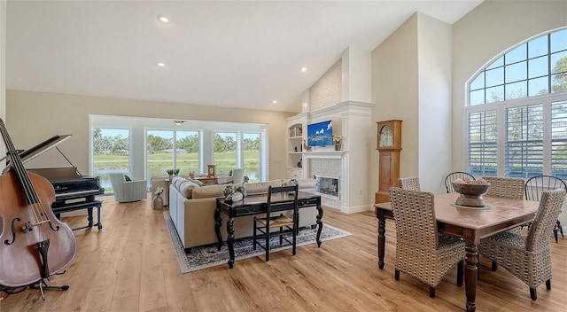4060 Penshurst Park, Sarasota, FL 34235 - interior space featuring light wood-style flooring, high vaulted ceiling, and a fireplace