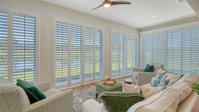 4060 Penshurst Park, Sarasota, FL 34235 - living area with ceiling fan, a wealth of natural light, and wood finished floors