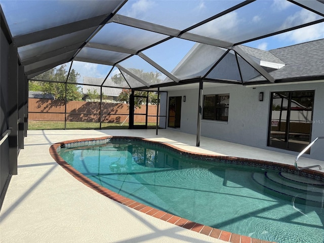 view of swimming pool with a fenced in pool, a lanai, fence, and a patio