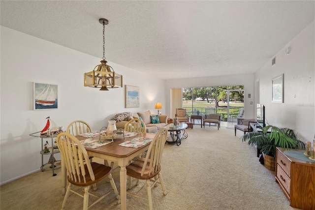 carpeted dining space with a textured ceiling and a notable chandelier