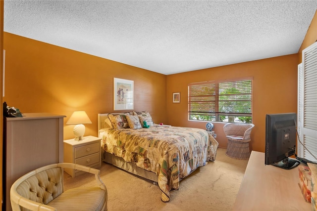 bedroom featuring carpet flooring and a textured ceiling