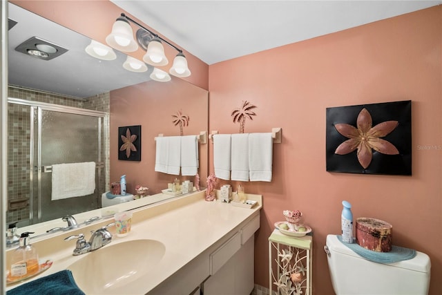 bathroom with vanity, toilet, and walk in shower