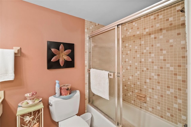 full bathroom with bath / shower combo with glass door, vanity, and toilet