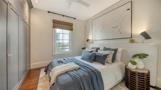 bedroom featuring ceiling fan and dark hardwood / wood-style flooring