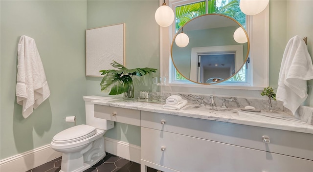 bathroom with vanity, tile patterned floors, and toilet